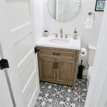 Fun and funky floor tile spruces up any morning in the bathroom with a tub included 